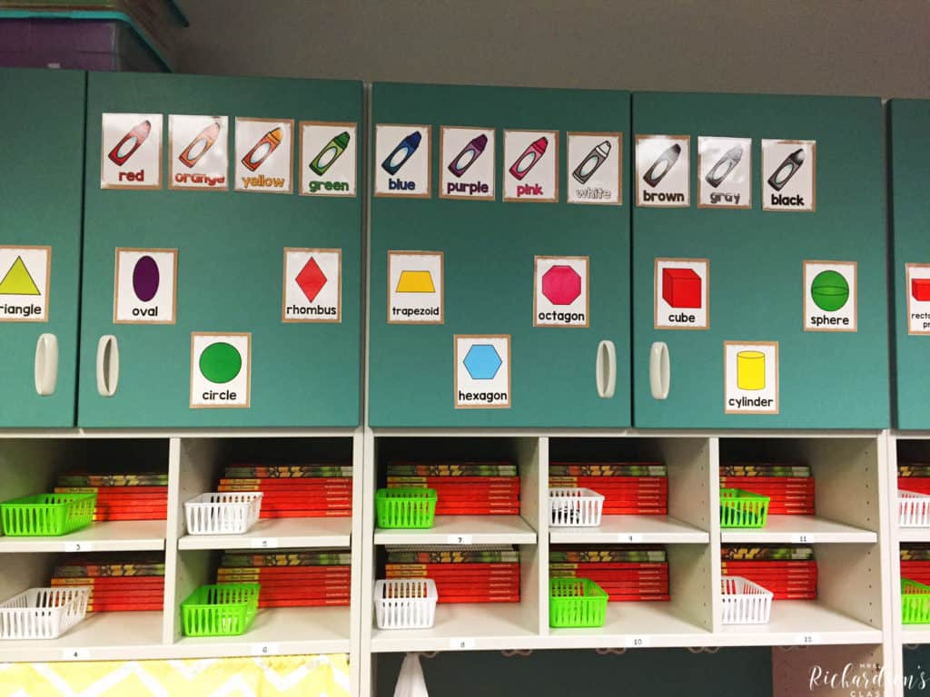 This teacher uses her storage cabinets to display her color posters and shape posters. She also stores student books in their cubbies, along with little baskets to hold ear buds. 